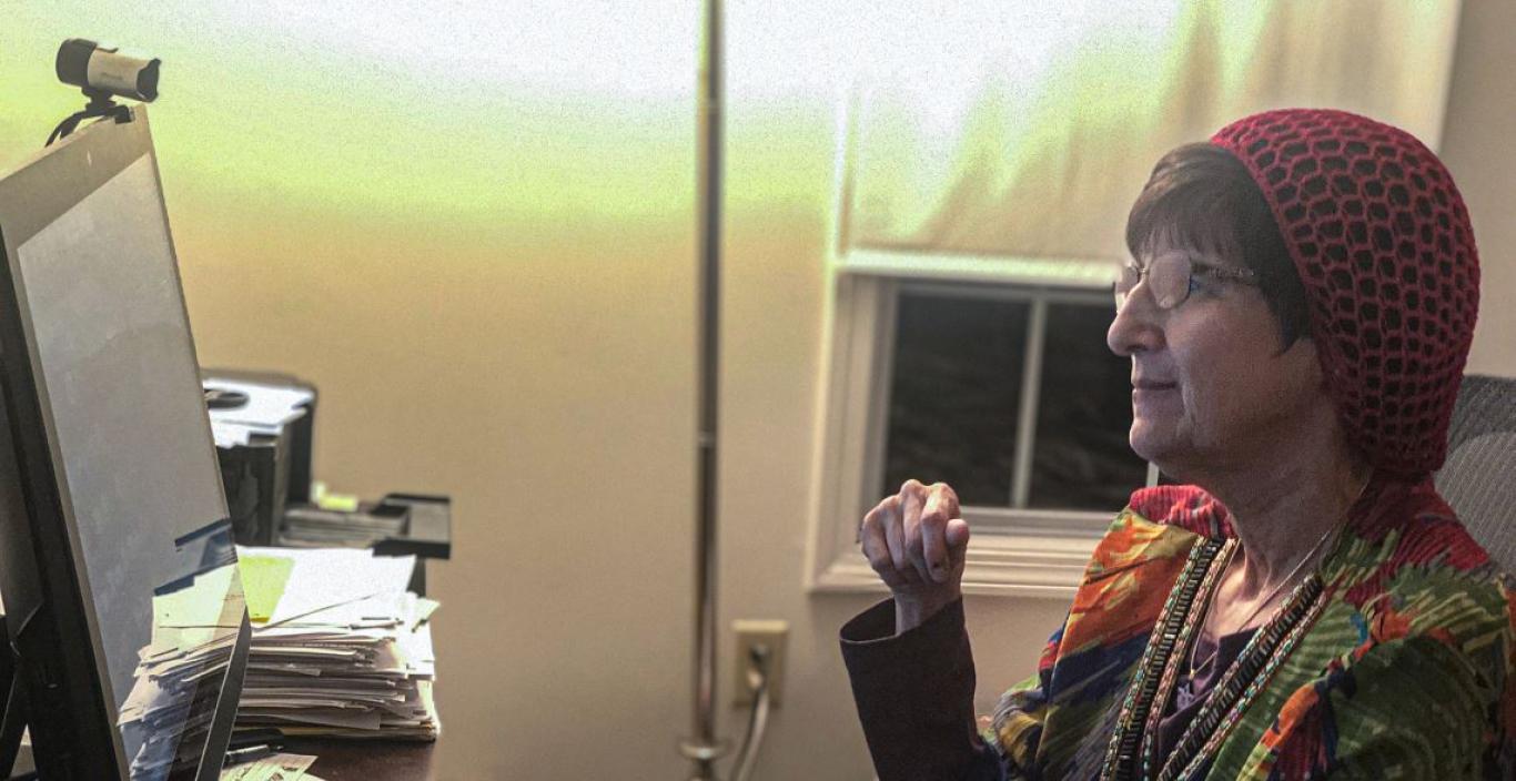 Donna Halper sitting in her office in front of a computer