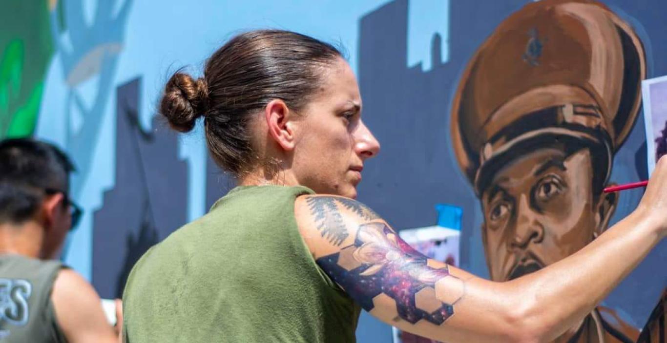 Sgt. Elize McKeley painting a mural