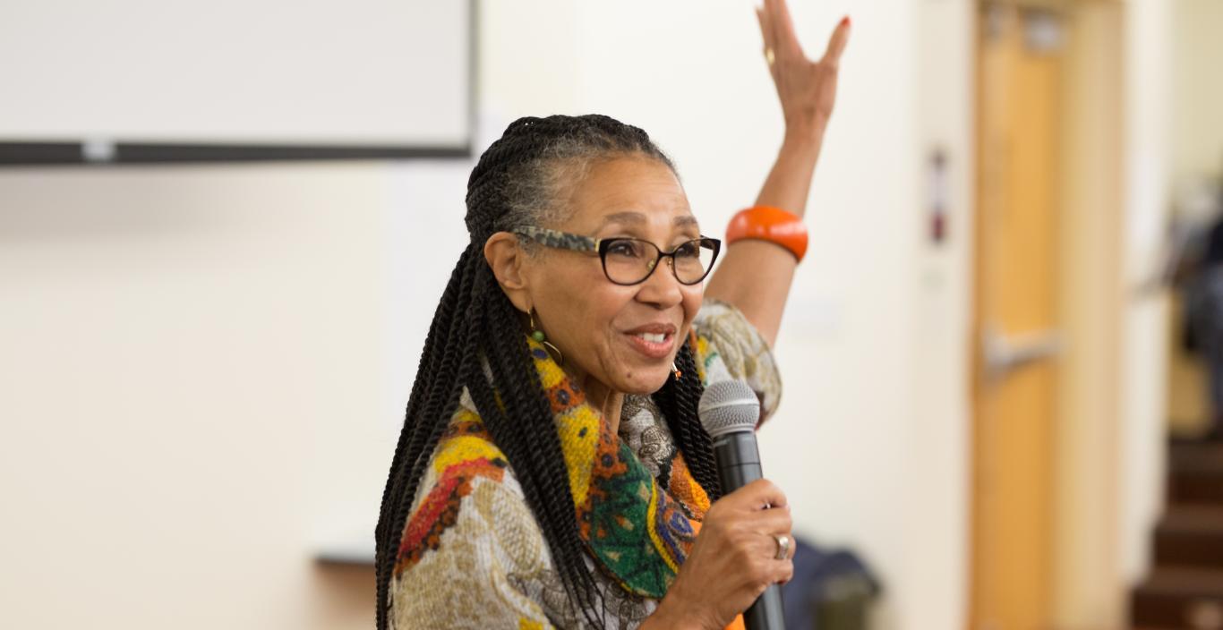 Rev. Gloria White-Hammond speaks. holding her left hand up.