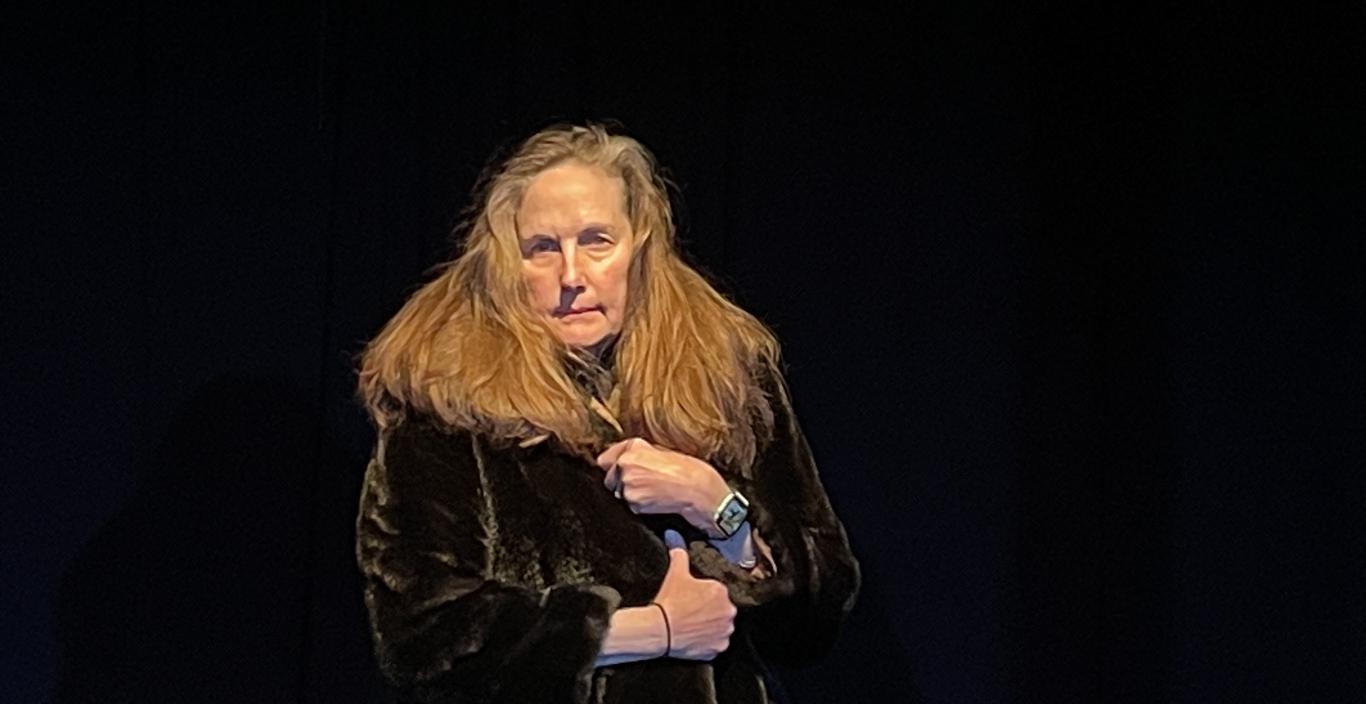 Jo-Anne Hart with microphone in black box theater
