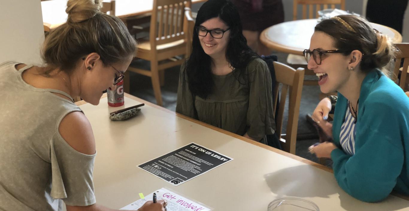 Students pictured staffing an information table in White Hall dining hall.