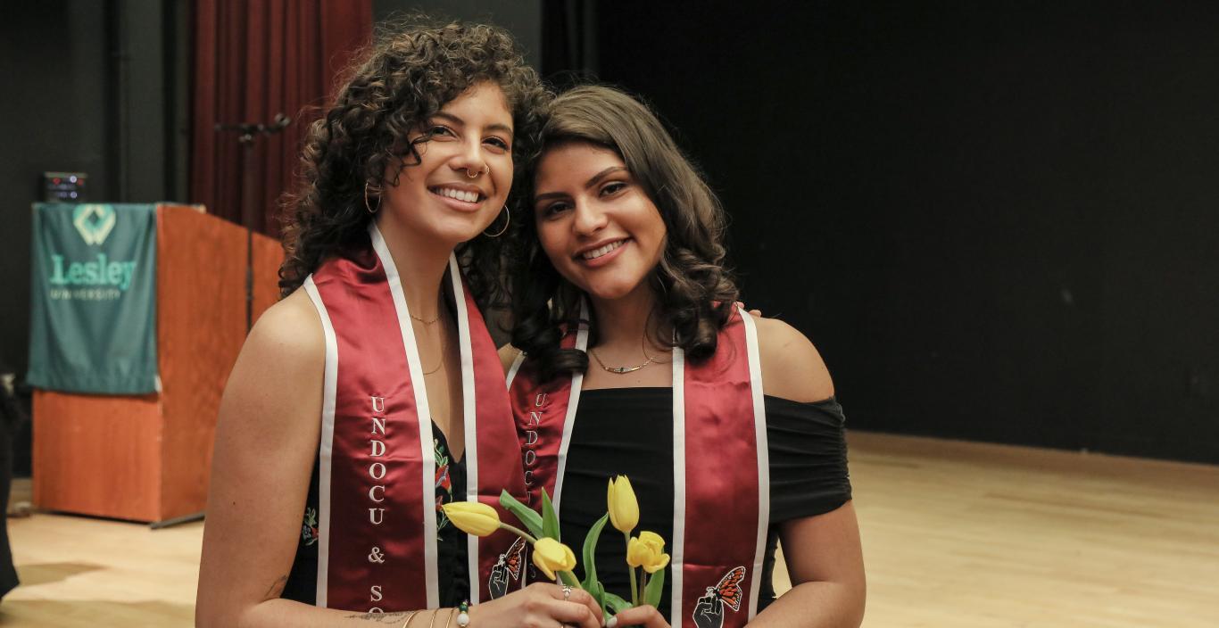 Jeannine Hernandez and Vita Franjul wearing the crimson stoles each graduate received