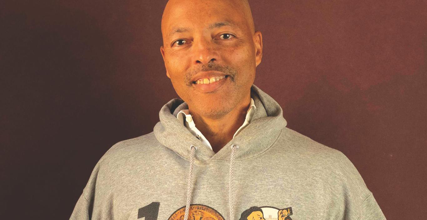 Jerry smiling wearing a sweatshirt that says "1 Newbery"