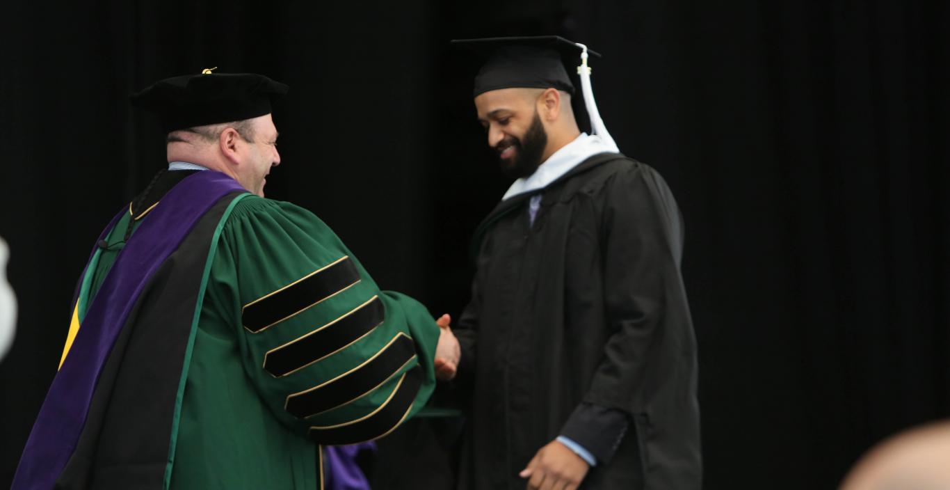 Jesse Sparks receives his diploma from President Jeff Weiss