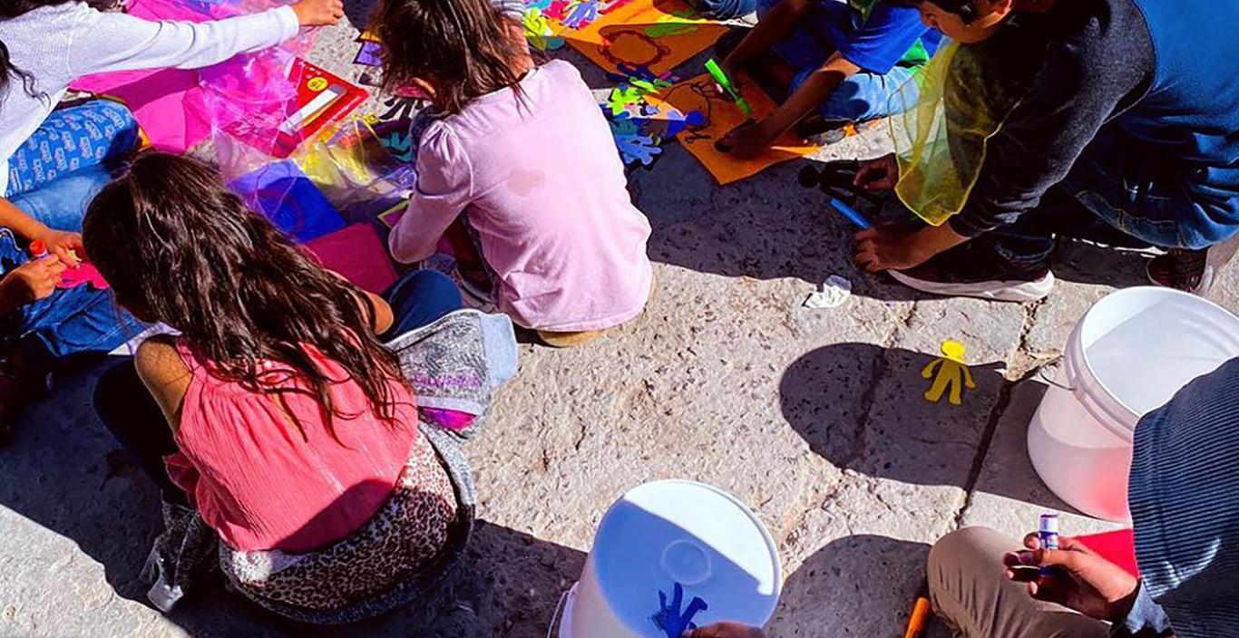 Kids sitting on the floor drawing