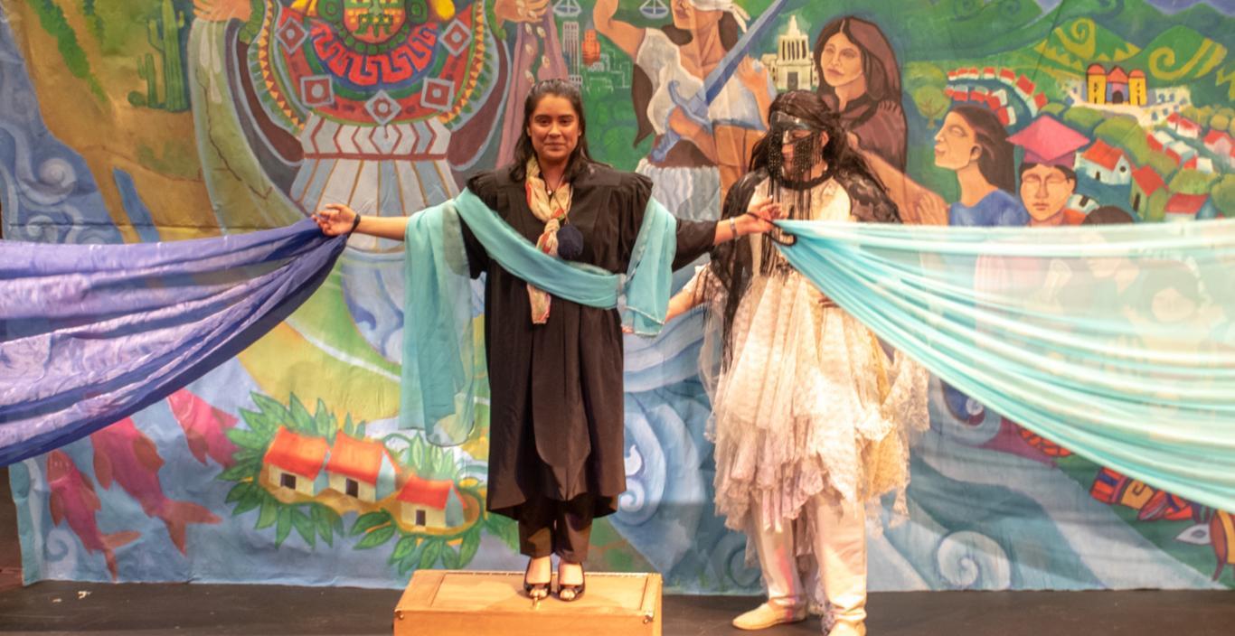 Judge Torres on stage with the mythical person behind her