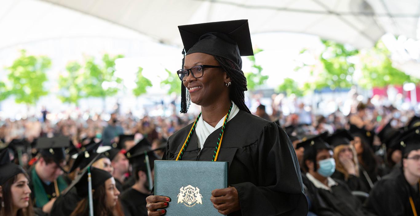 Julette Moore holding her degree at the 2022 Commencement Afternoon Ceremony.