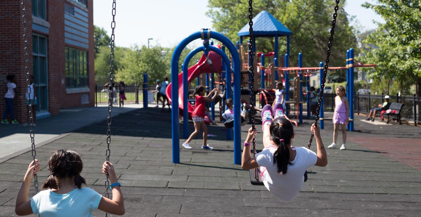 Kids swinging on a school playground