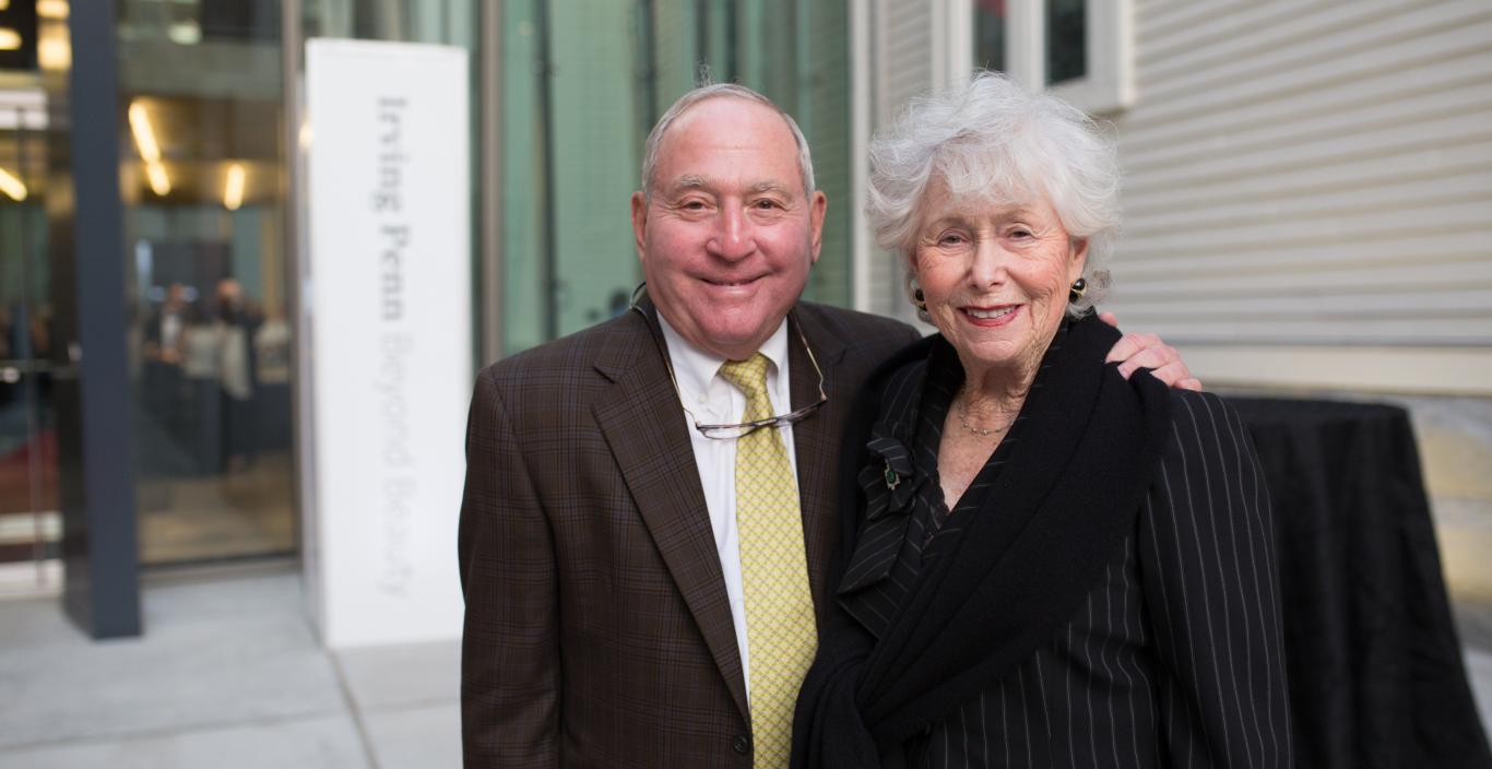 Peter and Paula Lunder pose in front of the Lunder Arts Center