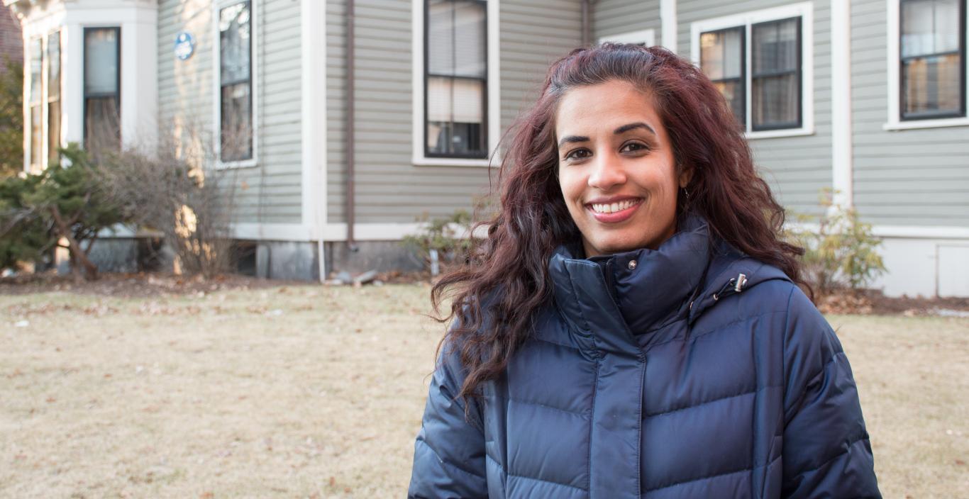 Outdoor shot of Mariya Taher in front of 29 Everett (founder's house at Lesley).