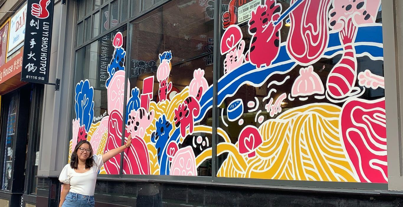 Nell Valle in front of her mural in Chinatown