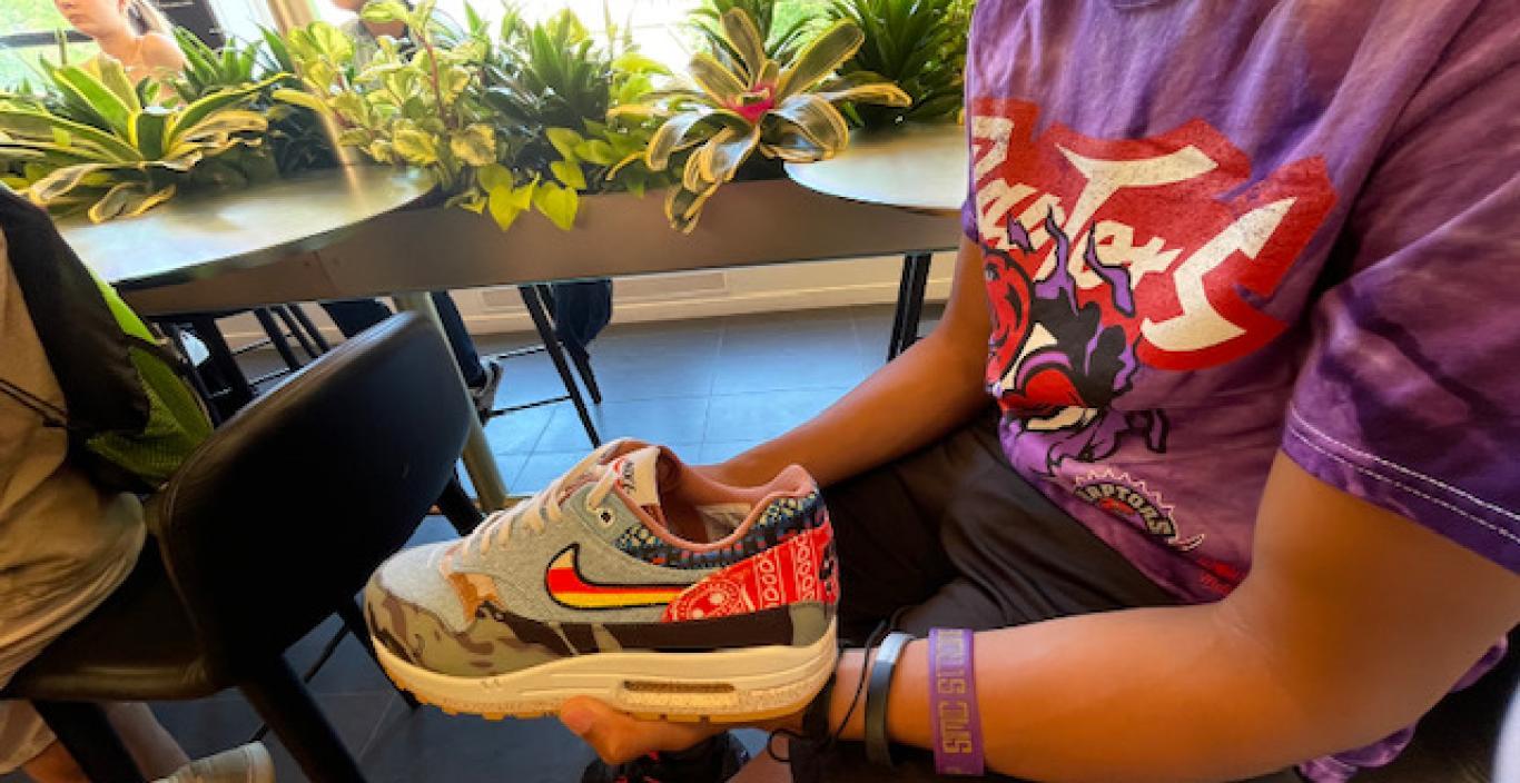 A student examines a Nike sneaker.