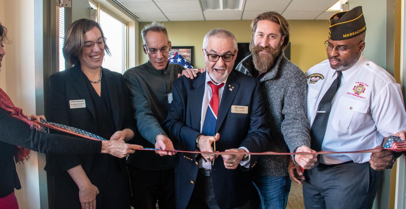 People cutting a ribbon at the opening of the Veterans' Center