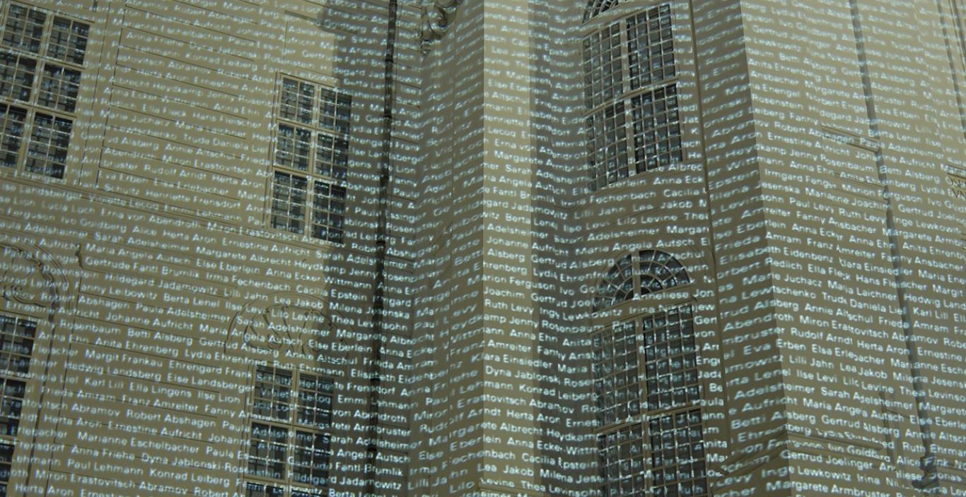 Thousands of names are projected onto a building.