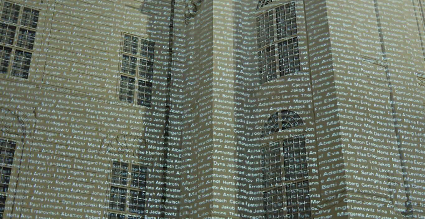 Thousands of names are projected onto a building.