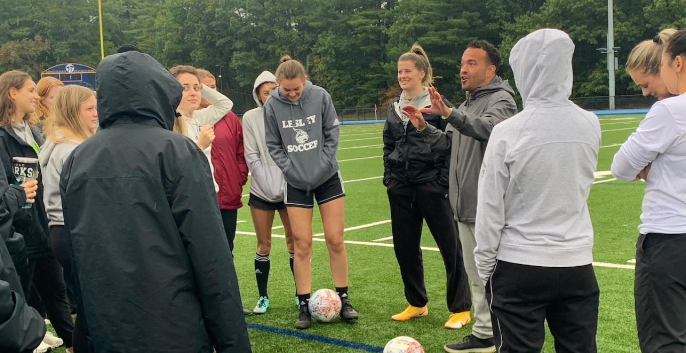 Assistant Athletic Director and women's soccer coach Paul Vasconcelos kicks off the alumni game