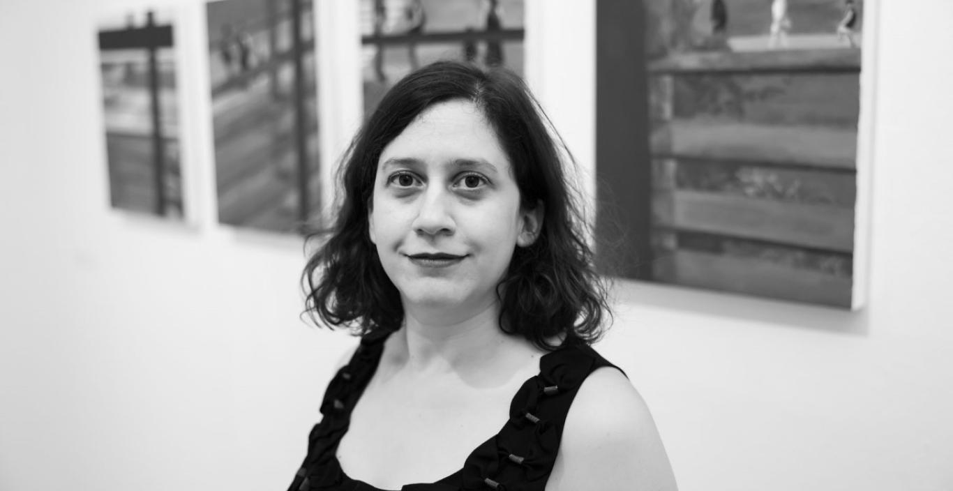 B&W photo of Azadeh Tajpour in front of her artwork