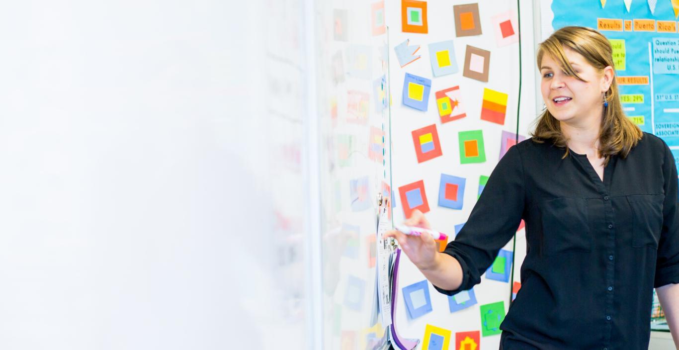 Teacher instructing at a whiteboard