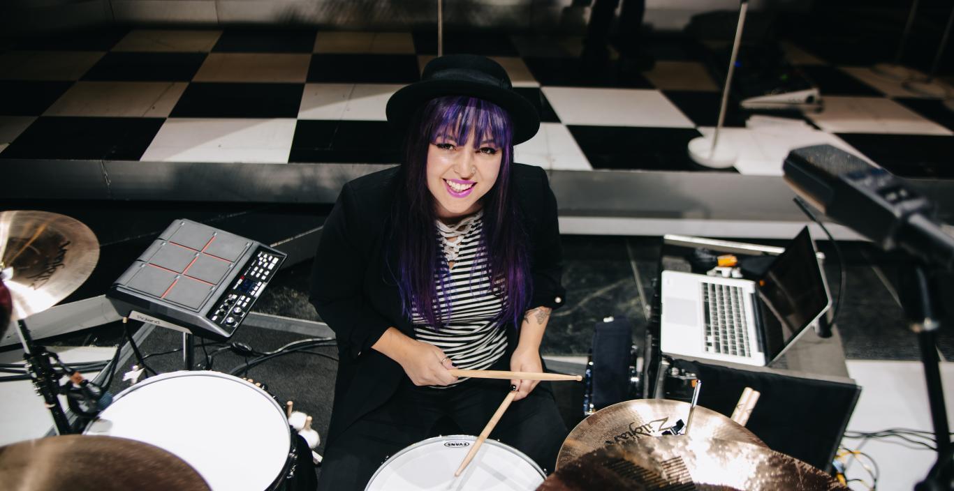 Drummer and Lesley alum Caitlin Kalafus sitting at her drum set.