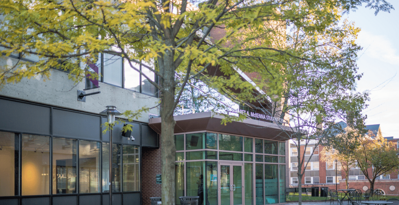 Outside photograph of the student center building on Doble quad with a green tree in front of it.