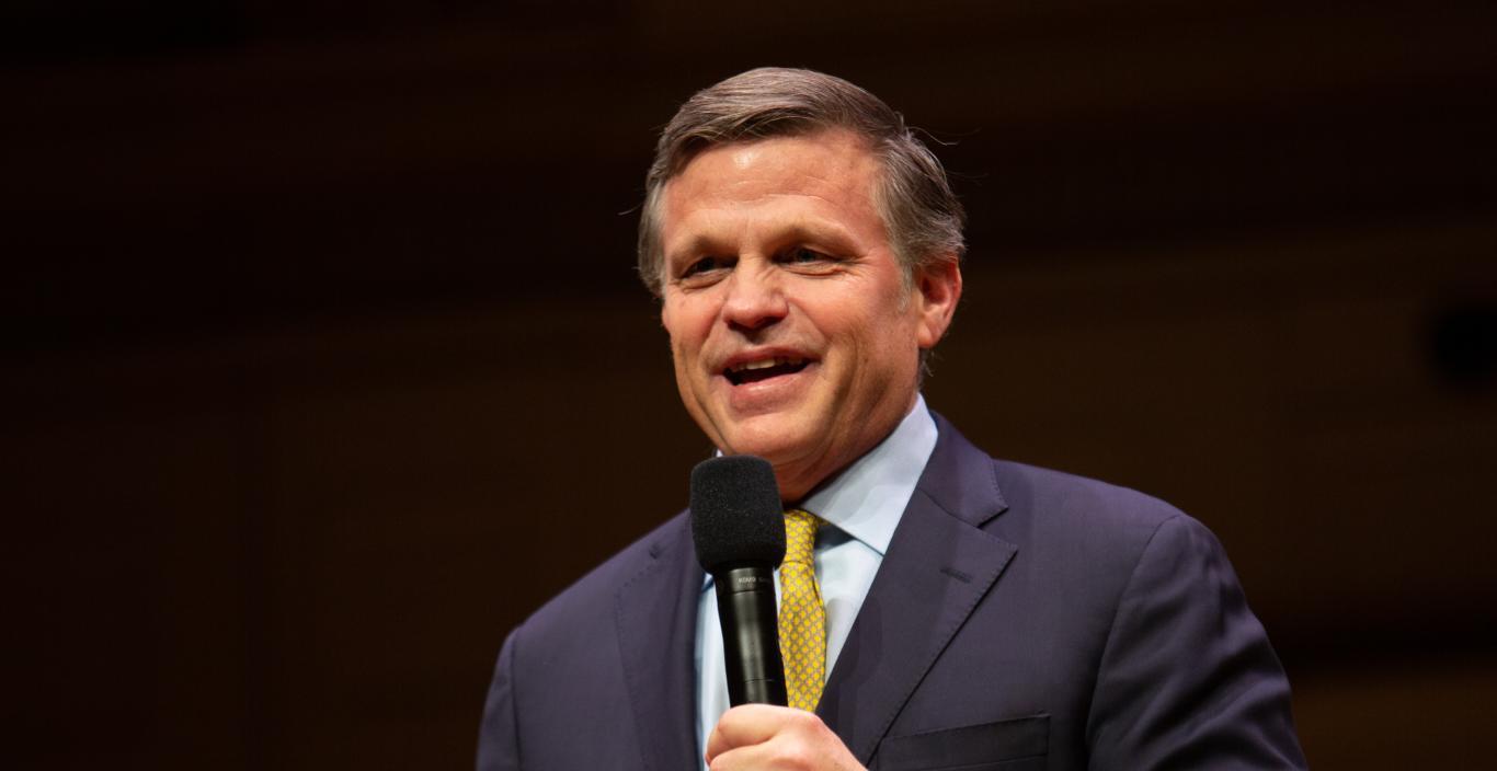 Douglas Brinkley holding a mic