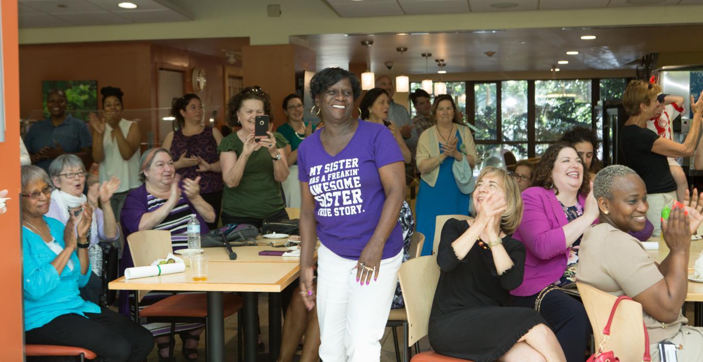 Regina Meadows, executive administrative assistant in the College of Liberal Arts and Sciences, is recognized during Lesley’s retirement celebration at the Student Center