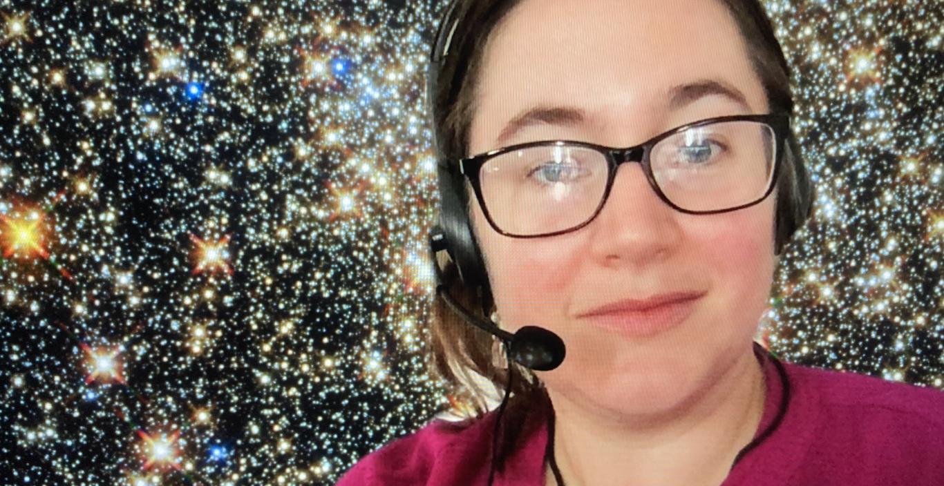 Photo of Giuliana Funkhouser wearing gaming headset in front of starry background