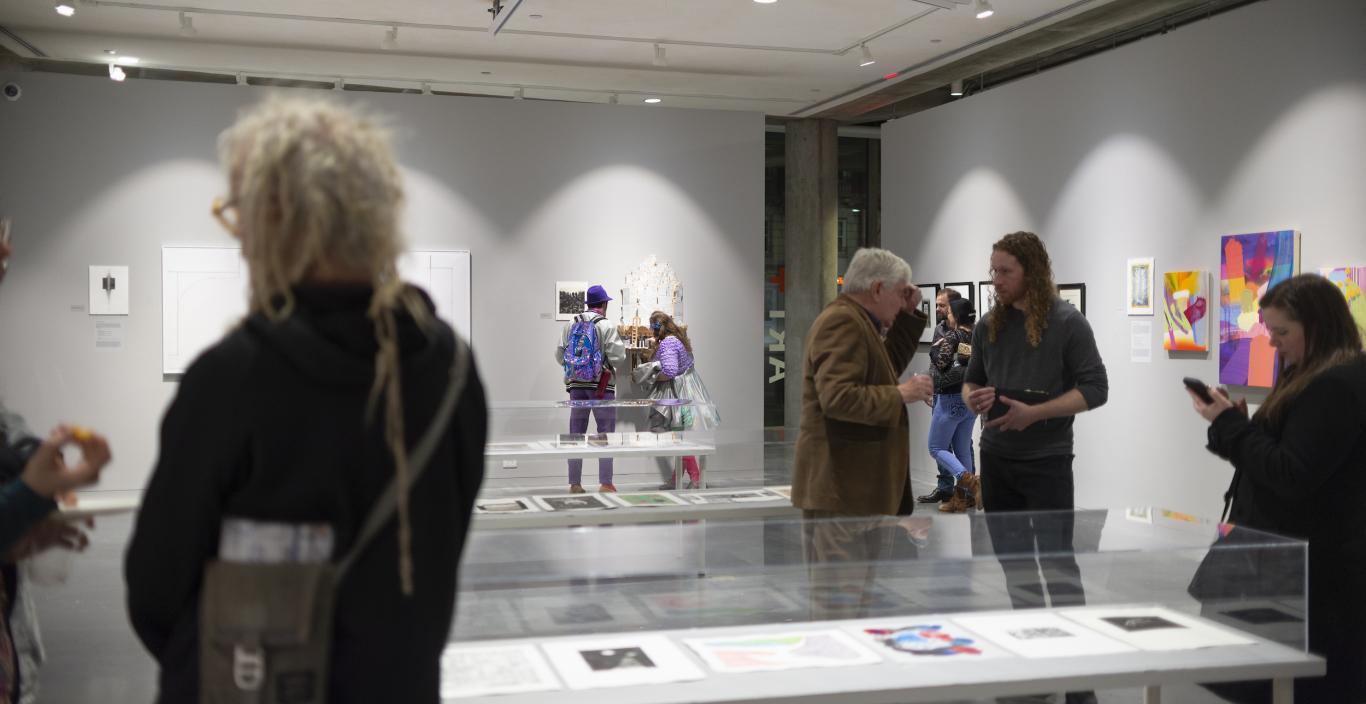 People in the Roberts Gallery during an exhibition looking at artwork