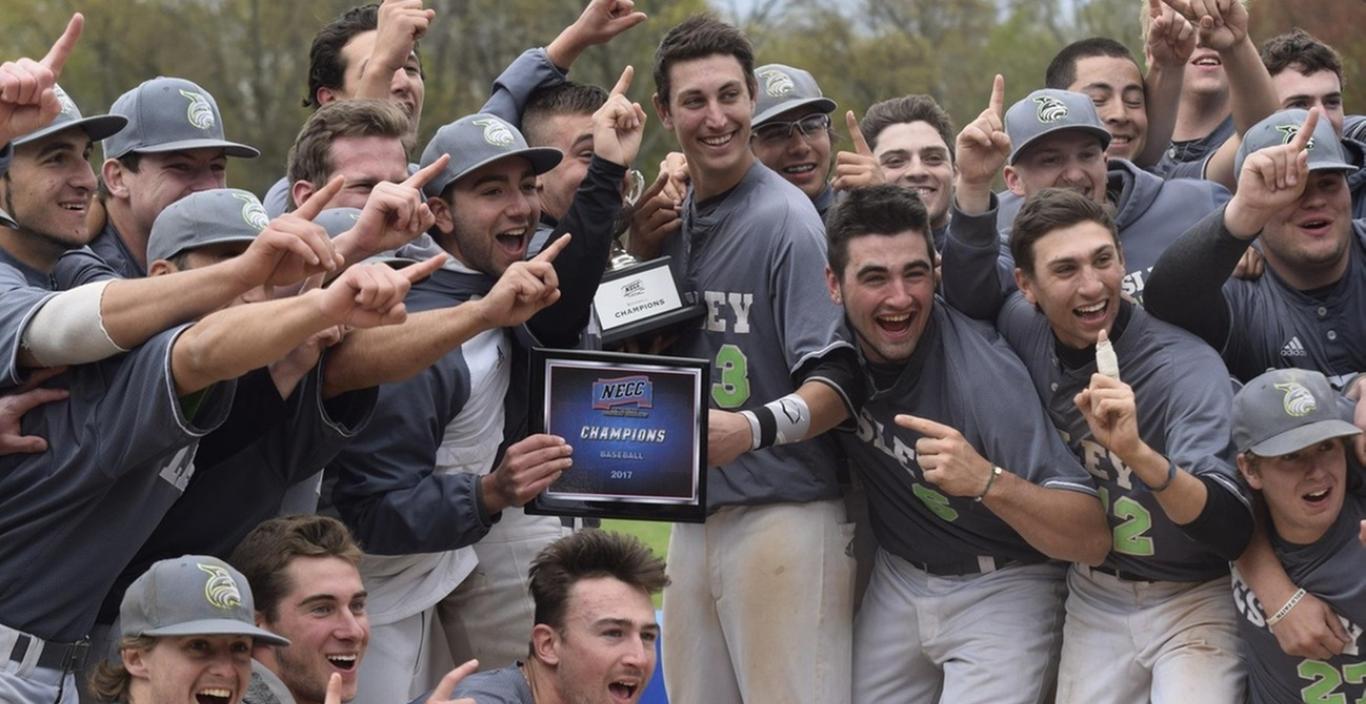 The baseball players celebrate their NECC win with their trophy.