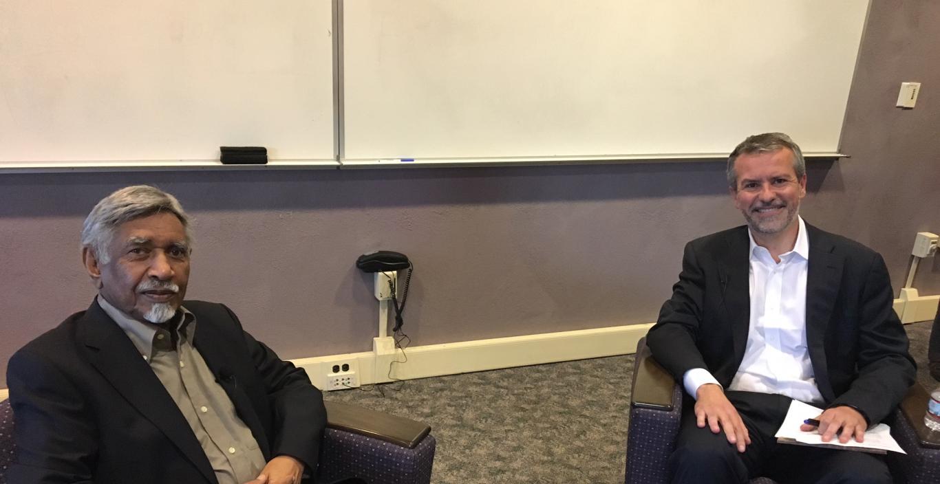Mac Maharaj seated in Sherrill Library with moderator Roger Berry