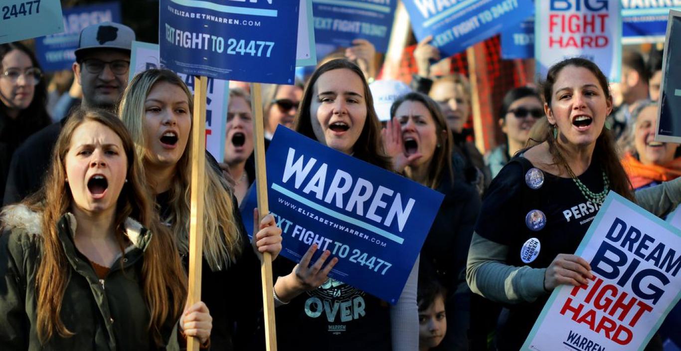 A group of women holding Elizabeth Warren signs at a rally