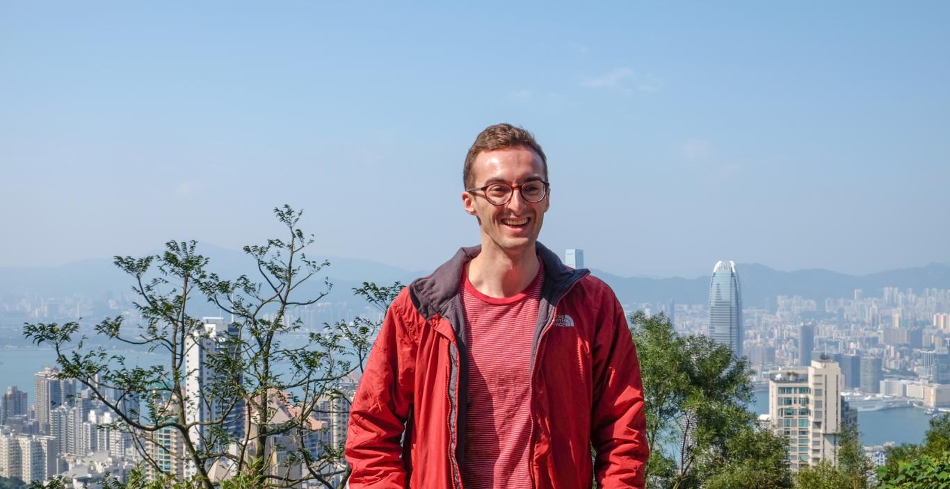 student outside smiling overlooking California hills