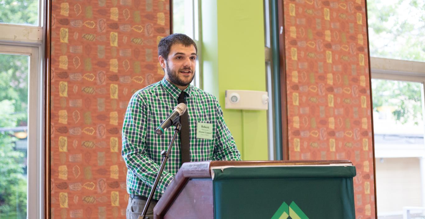 Robert Mitropoulos speaking at a podium during Alumni Weekend.