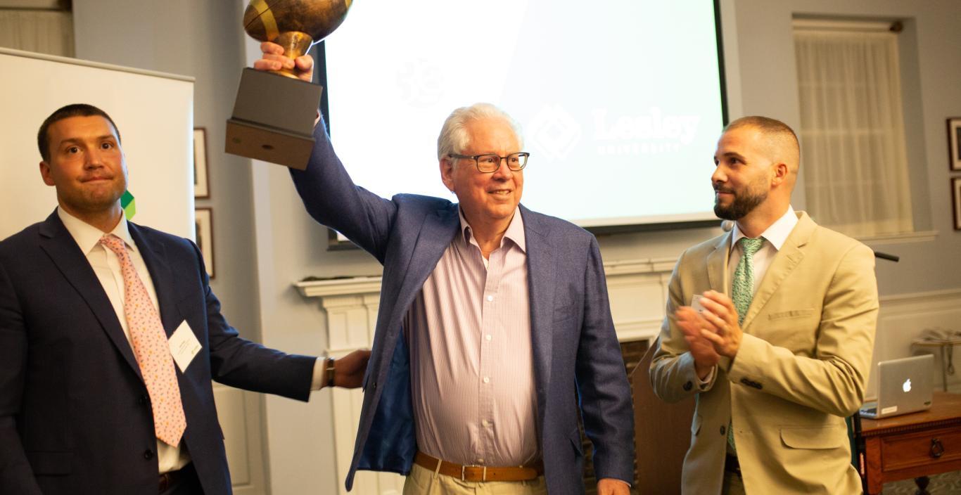 George Weiss holds up a bronze football jersey