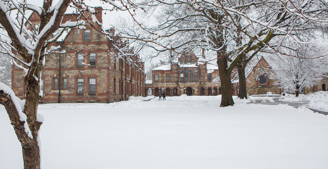 Winter scene on Lesley's western campus with 2 students in the background