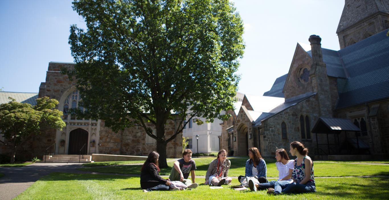 Students in an arc, chatting on Lesley's lawn.