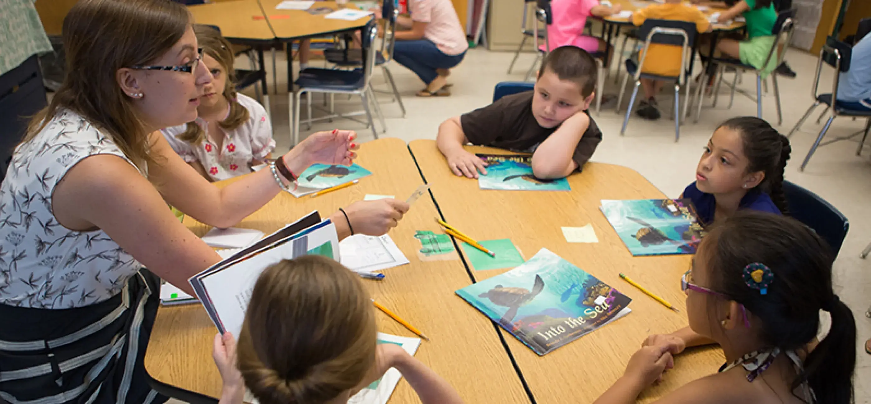 Teacher and Students reading books