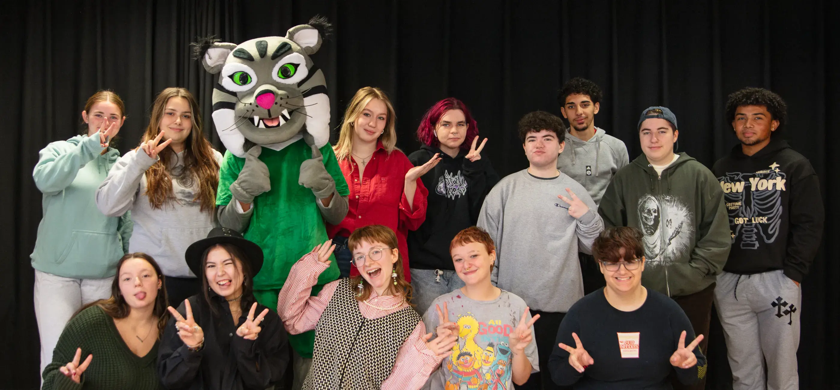 Group of Lesley students posing around Lynx mascot