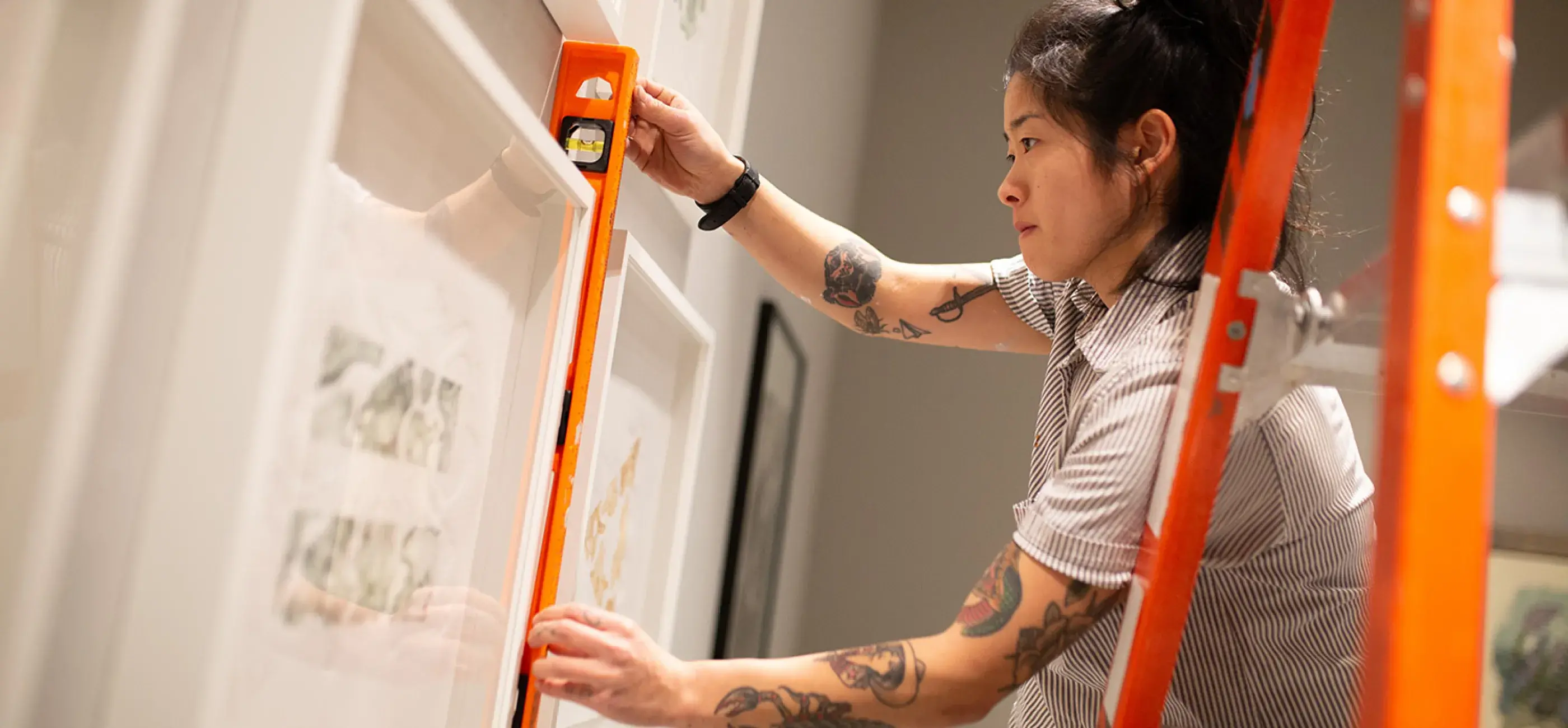 artist measuring art hanging