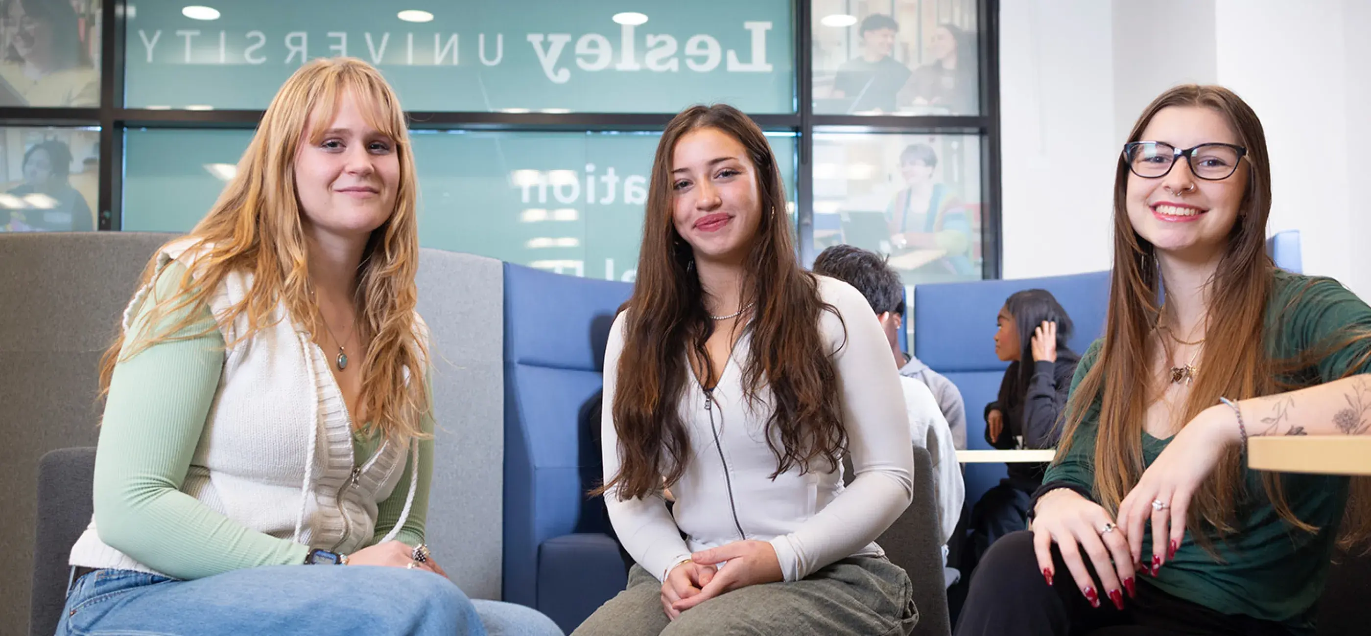 3 girls smile in lounge