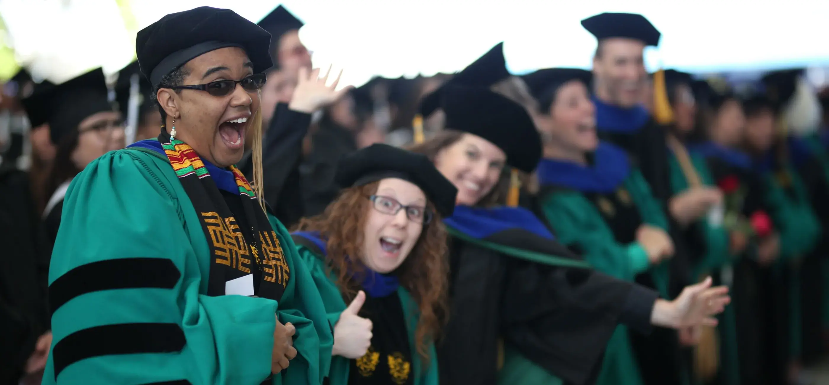 Smiling PhD graduates