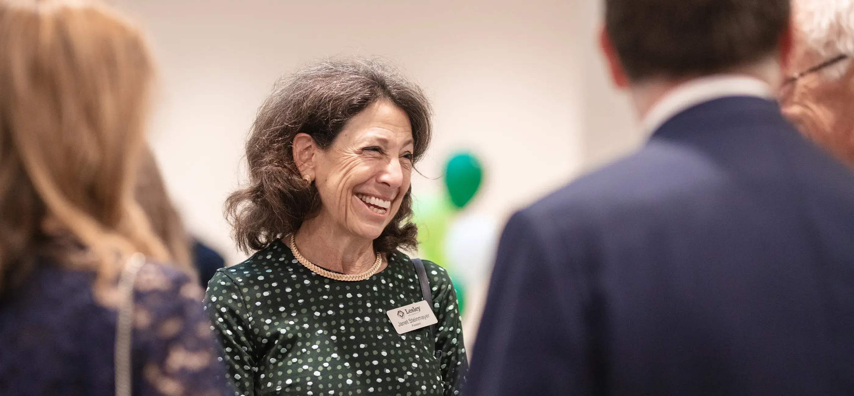 president janet steinmayer speaking with a group of people