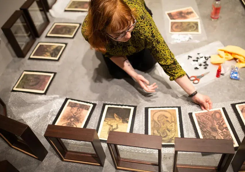 student placing illustrations in frames