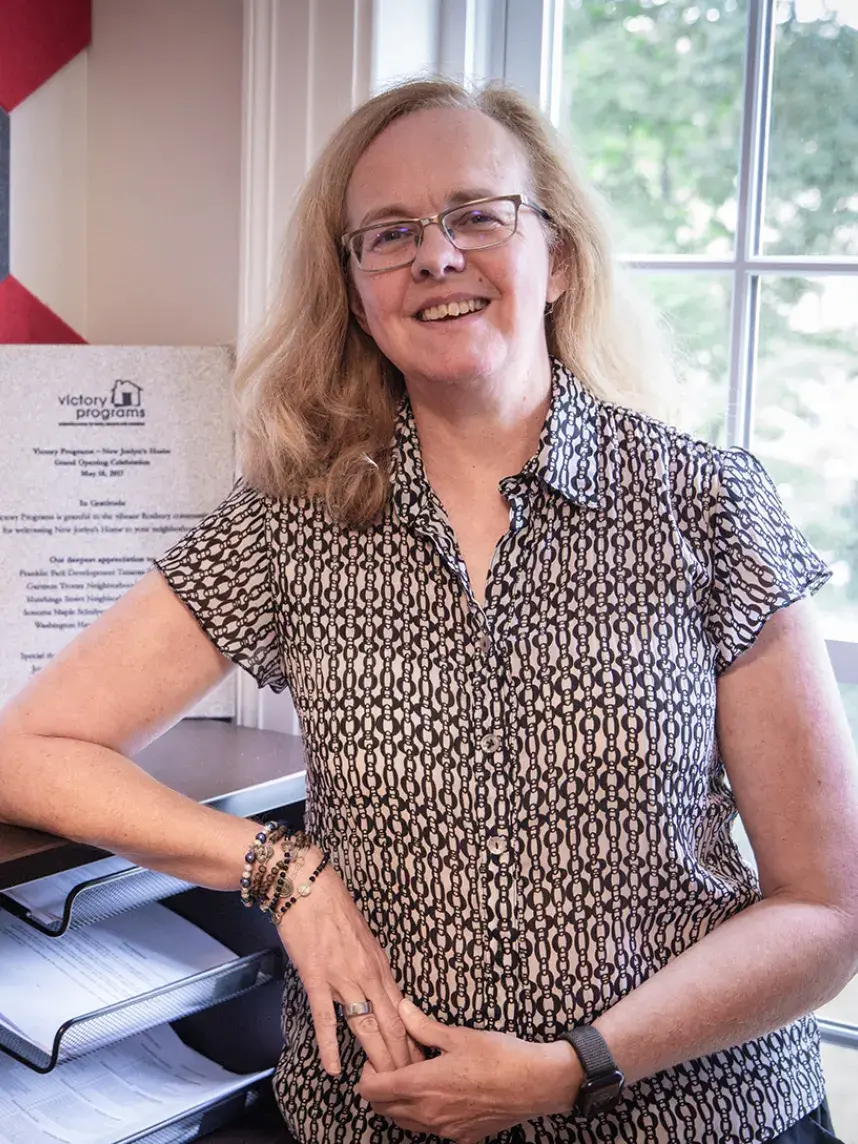 Woman leaning on bookcase