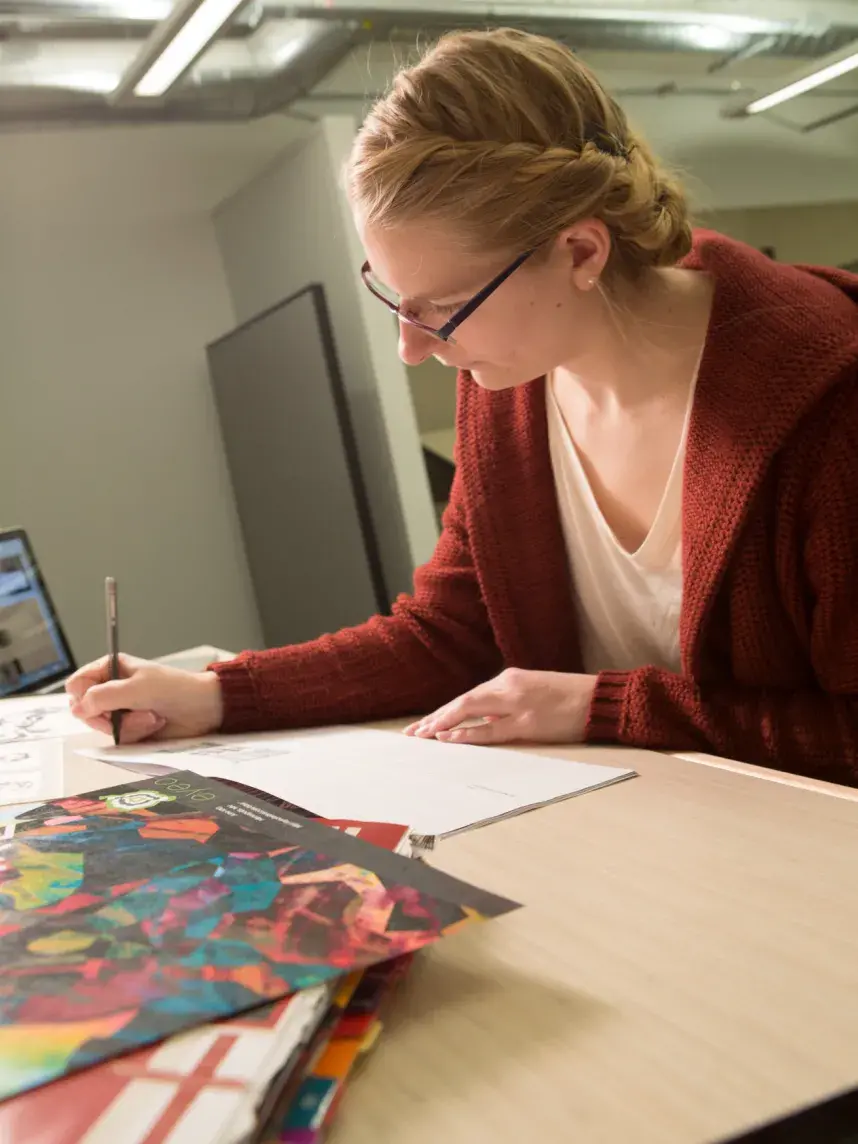 student writing at desk
