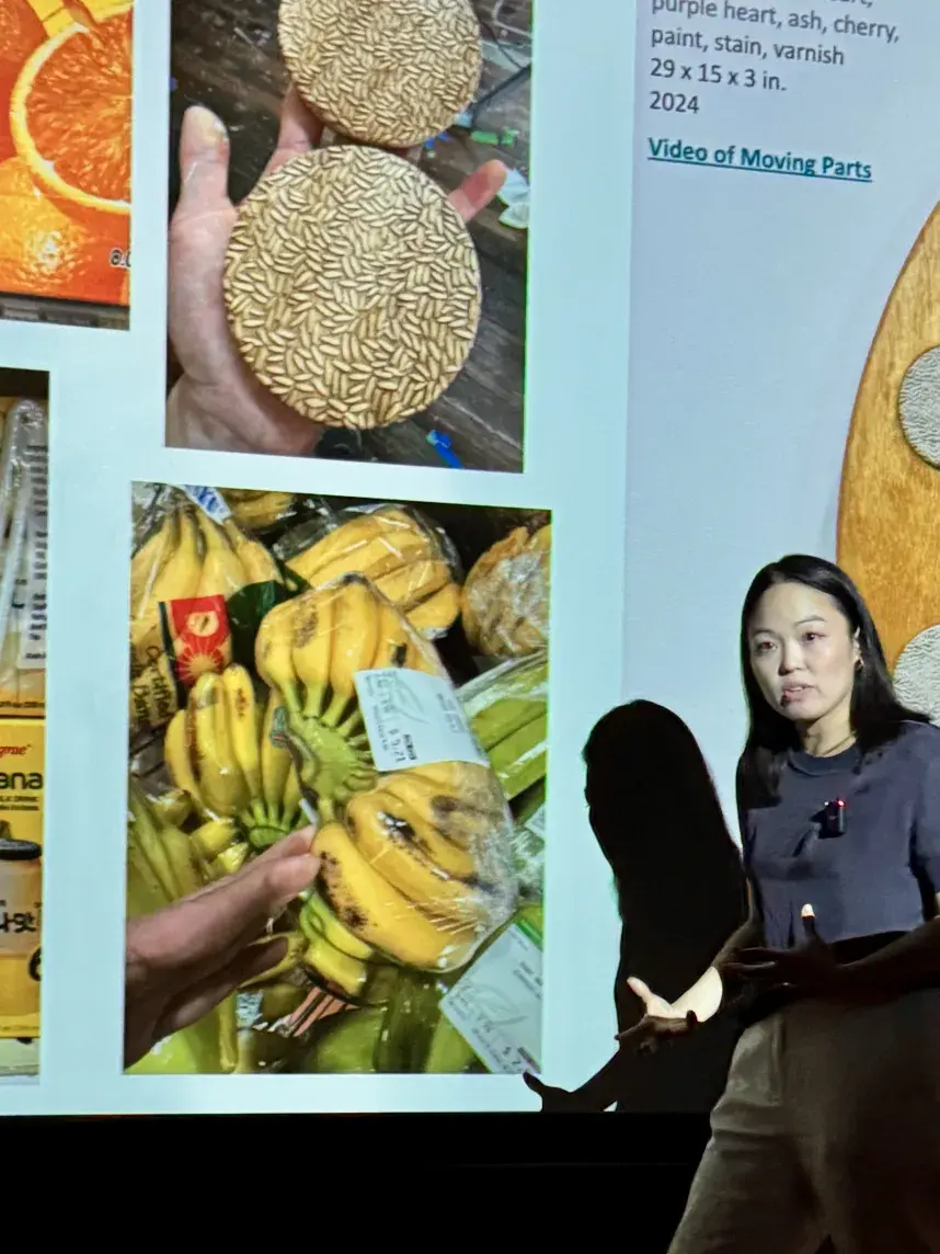 Student stands in front of a projected presentation