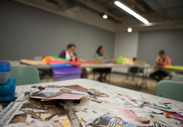 Students in a Lesley classroom making art through collage