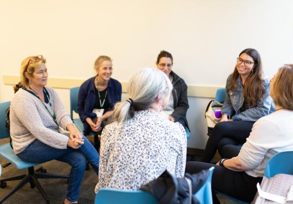 Students Sitting in Circle Having Discussion