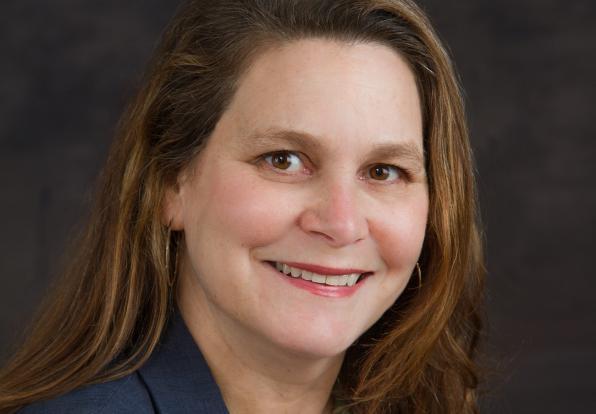 Headshot of Carolyn Jeppsen with black background