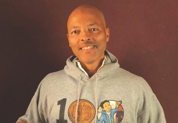 Jerry smiling wearing a sweatshirt that says "1 Newbery"